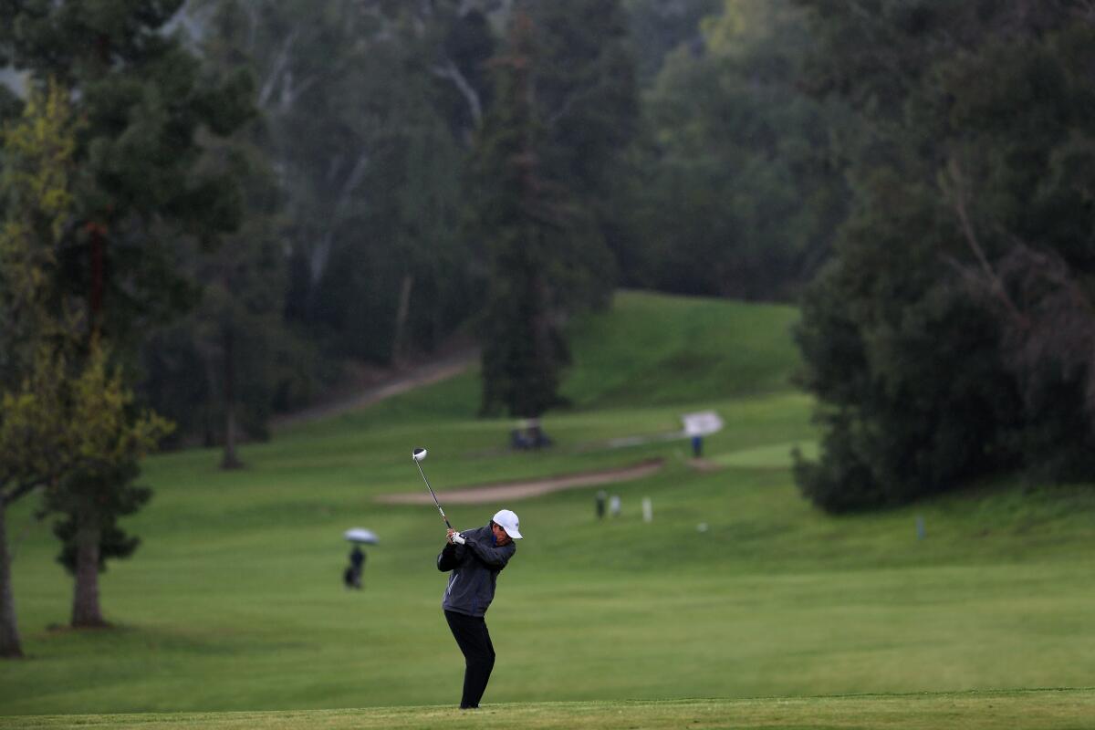 A golfer plays at Griffith Park. 