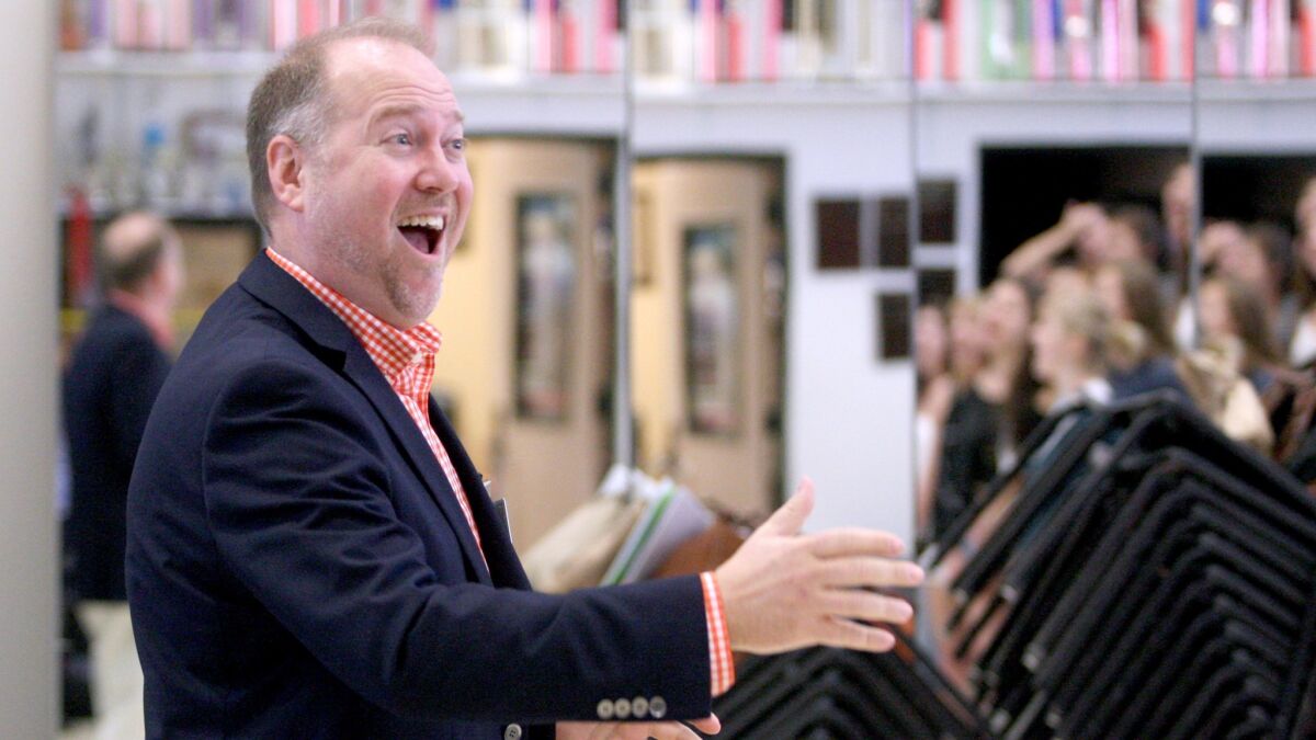 Burbank High show choir director Brett Carroll conducts students during practice, in this file photo taken Tuesday, Sept. 22, 2015.