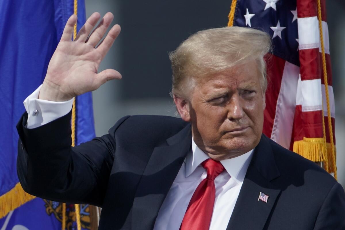 President Donald Trump leaves stage after speaking at an event in Marinette, Wis., Thursday