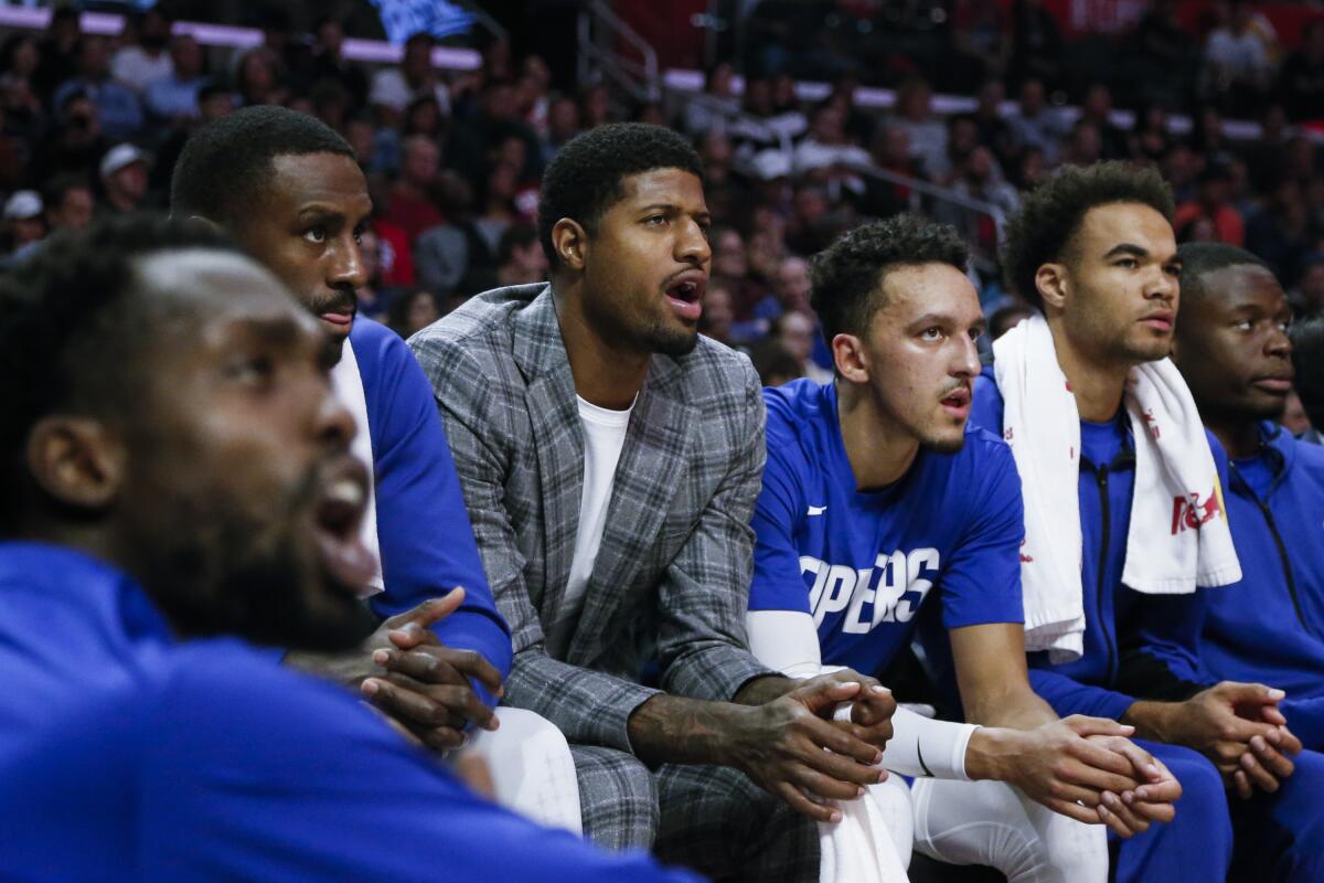 Clippers' Paul George watches on the bench during a game against the Utah Jazz on Sunday at Staples Center.