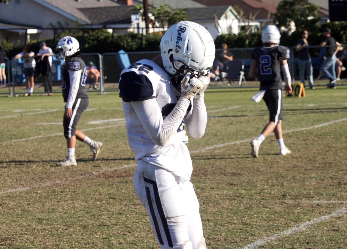 Flintridge Prep's Zach Kim (22) is emotional after loosing to Windward School 47-17 during Flintridge Prep football team competing against Windward School in the CIF Southern Section Division 1 eight-man semifinal football game at the Windward School football field in Los Angeles, Ca., Saturday, November 23, 2019. (photo by James Carbone)