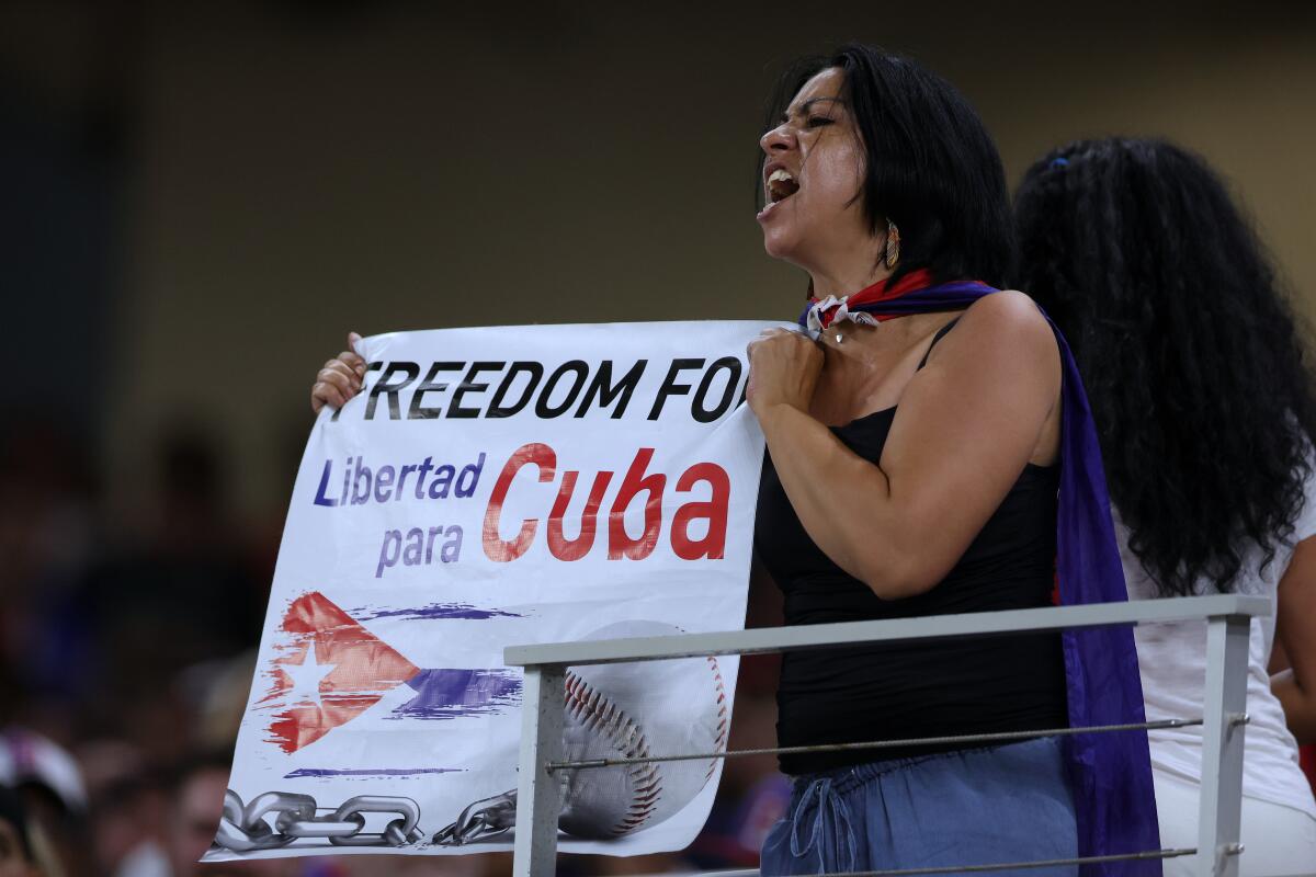 A fan holds a sign protesting the Cuban government during Sunday's World Baseball Classic semifinal in Miami.