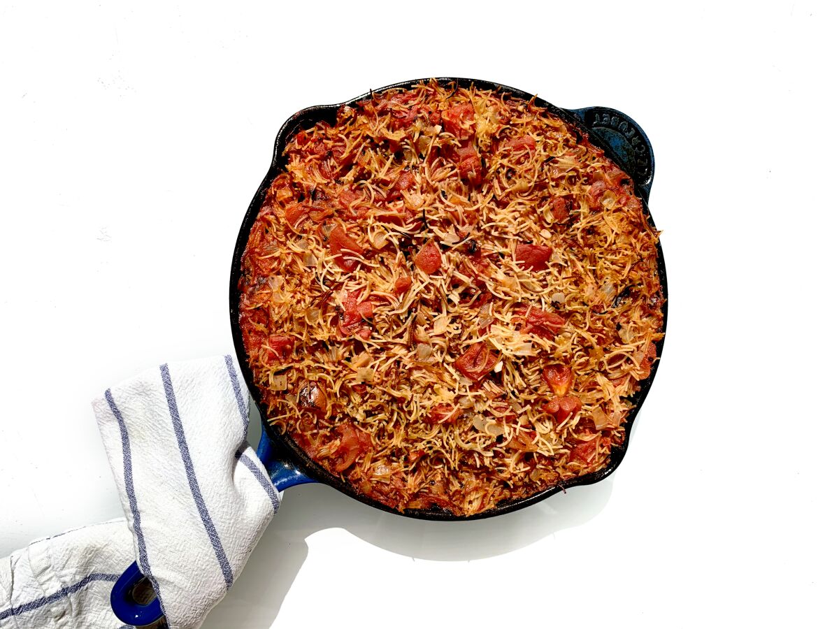 Overhead shot of a skillet filled with pasta in a red sauce.