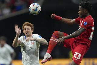 Panama's Michael Murillo, right, jumps for a ball challenged by Josh Sargent of the United States.