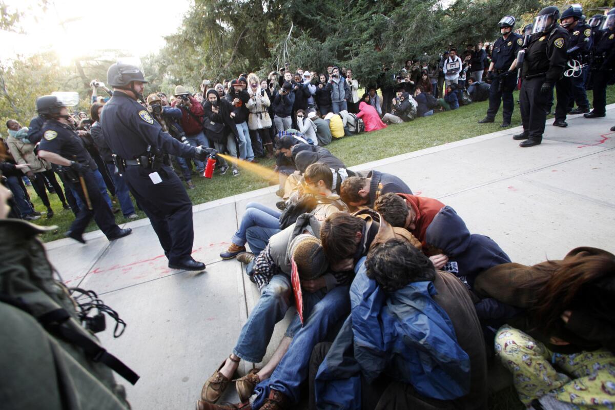 Then-UC Davis police Lt. John Pike hits protesters with pepper spray on Nov. 18, 2011.