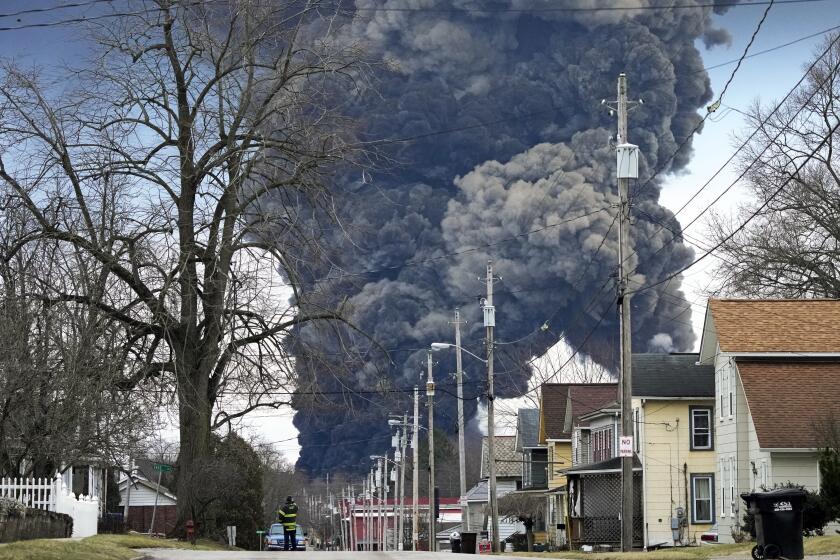 FILE - A black plume rises over East Palestine, Ohio, as a result of the controlled detonation of a portion of the derailed Norfolk Southern trains Monday, Feb. 6, 2023. The head of the National Transportation Safety Board told Congress Wednesday, March 6, 2024, that decision to blow open five tank cars and burn the toxic chemical inside them three days after a Norfolk Southern train derailed in Eastern Ohio last year wasn't justified. But NTSB Chair Jennifer Homendy said the key decision makers who feared those tank cars were going to explode never had all the information they needed. (AP Photo/Gene J. Puskar, File)