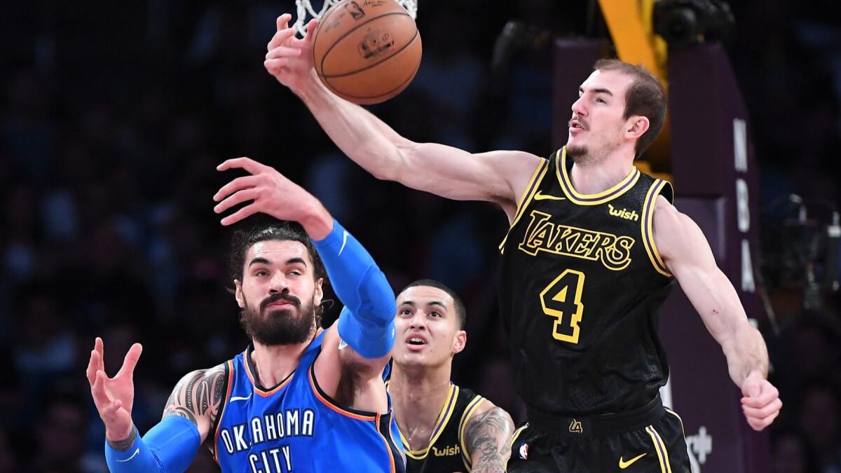Lakers guard Alex Caruso intercepts a pass intended for Thunder center Steven Adams during a game last season.