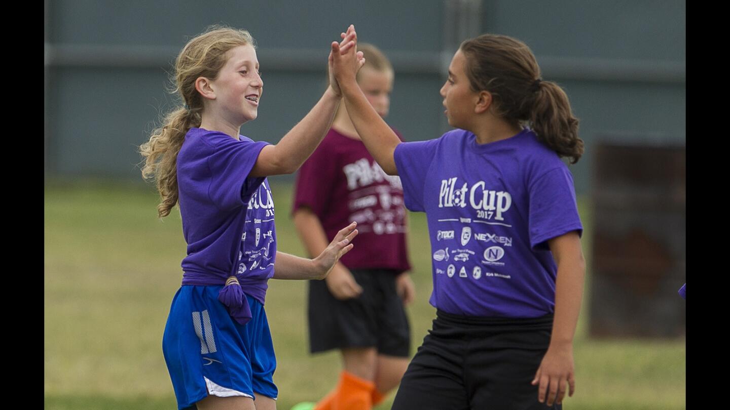 Newport Coast's Taryn Hill, right, high fives Helena Litvak afte she scored a goal during a Daily Pilot Cup girls' 3-4 silver division game against Sonora on Wednesday, May 31.