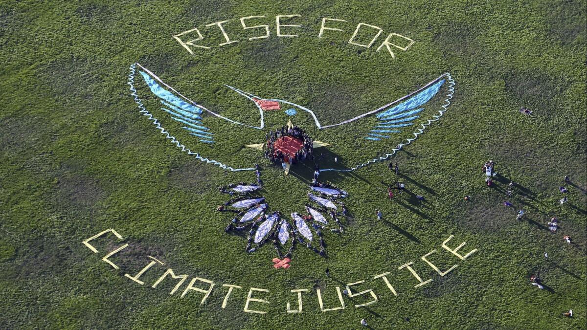 A "Solar Hummingbird" human installation in San Francisco calls for climate justice.