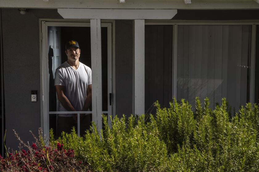 Costa Mesa CA, SUNDAY, MAY 3, 2020, - Former NFL player and LA firefighter Eric Stevens, 30, suffers from ALS. He is one of dozens of former NFL players with disease at a rate far above the general population. He is photographed at home with his wife, Amanda. (Robert Gauthier / Los Angeles Times)