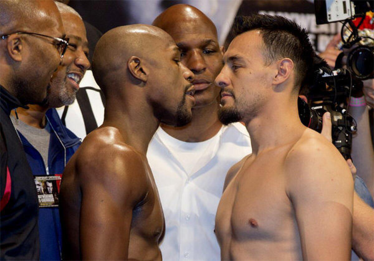 Floyd Mayweather Jr., left, faces off with Robert Guerrero after their weigh-in.