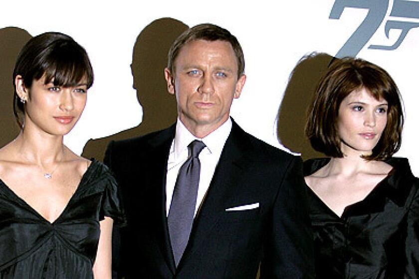 Daniel Craig, James Bond himself, poses with the newest Bond girls to hit the franchise -- Gemma Arterton and Olga Kurylenko -- at the announcement of the name for the latest Bond movie, Quantum of Solace, at Pinewood Studios.