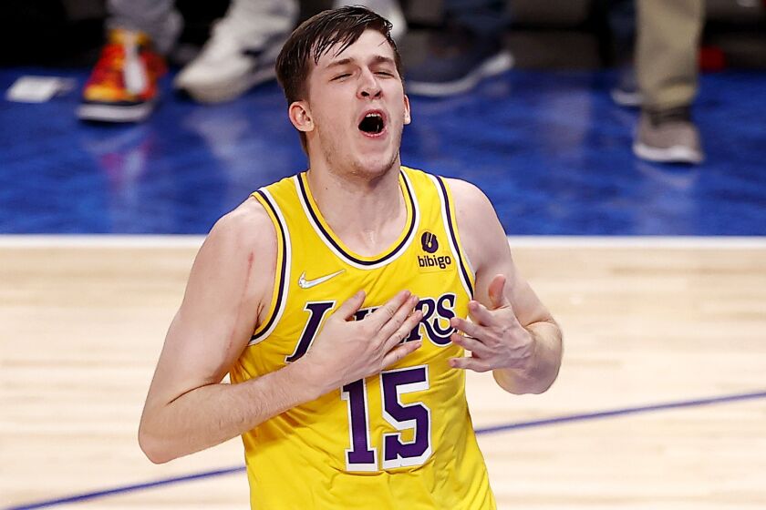 DALLAS, TEXAS - DECEMBER 15: Austin Reaves #15 of the Los Angeles Lakers reacts after shooting the game-winning shot against Tim Hardaway Jr. #11 of the Dallas Mavericks in overtime at American Airlines Center on December 15, 2021 in Dallas, Texas. (Photo by Tom Pennington/Getty Images)