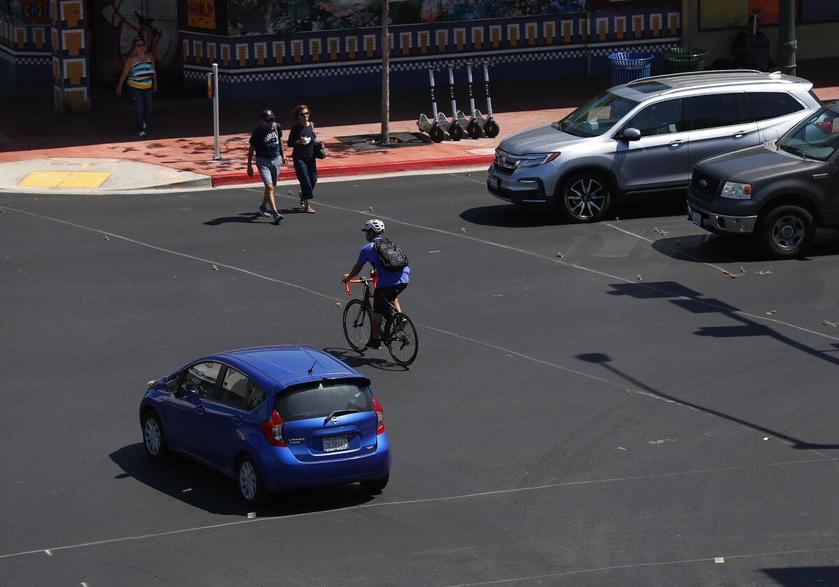 A bicyclist rides on 30th Street at University Ave. in the 30th Street Protected Bikeways Mobility Project 