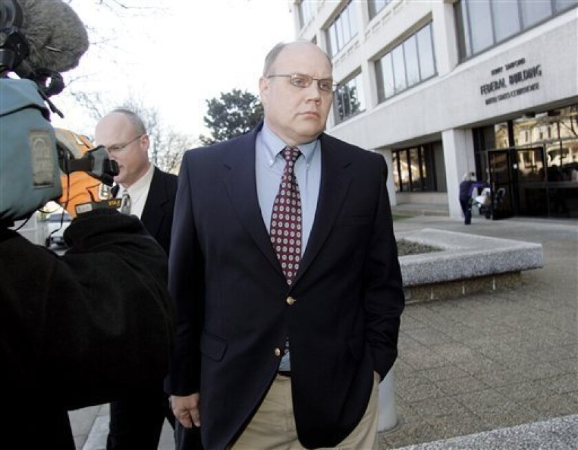 FILE - In this Friday, Feb. 26, 2010 picture, Master Sgt. Timothy Hennis leaves the Terry Sanford Federal Building and Courthouse after a federal hearing in Raleigh, N.C. The soldier who was acquitted of killing a mother and two of her young daughters in North Carolina more than 20 years ago is now going on trial in military court after new DNA tests linked him to the crimes. (AP Photo/Jim R. Bounds)