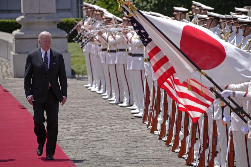 U.S. President Joe Biden, left, and with Japan's Prime Minister Fumio Kishida, reviews an honor guard during a welcome ceremony for President Biden, at the Akasaka Palace state guest house in Tokyo, Japan, Monday, May 23, 2022. (AP Photo/Eugene Hoshiko, Pool)
