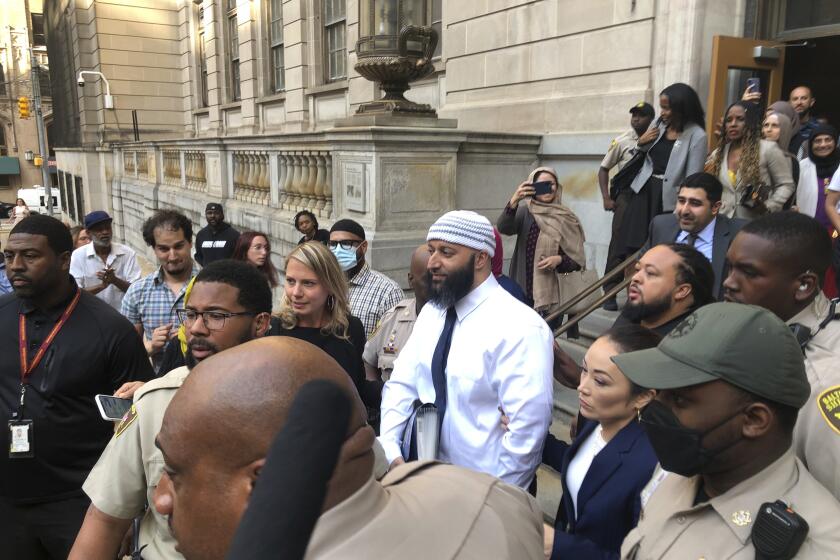 Adnan Syed, center, leaves the Elijah E. Cummings Courthouse, Monday, Sept. 19, 2022, in Baltimore. A judge has ordered the release of Syed after overturning his conviction for a 1999 murder that was chronicled in the hit podcast “Serial.” (AP Photo/Brian Witte)