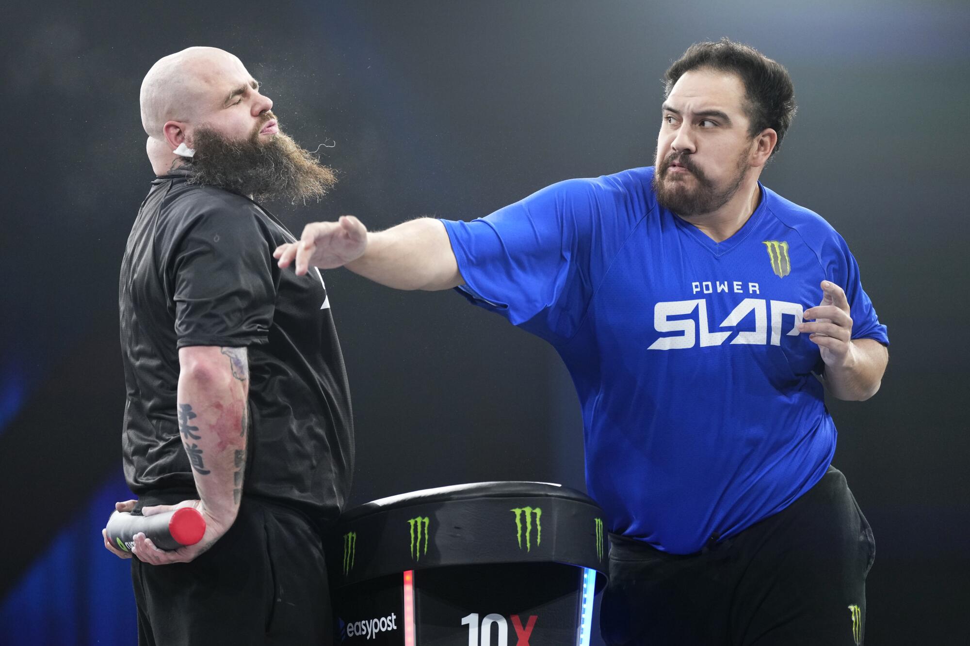 LAS VEGAS, NEVADA - MARCH 11: Dorian 'Disturbing The Peace' Perez strikes Frank 'The Tank' Holland during the Power Slap 1.