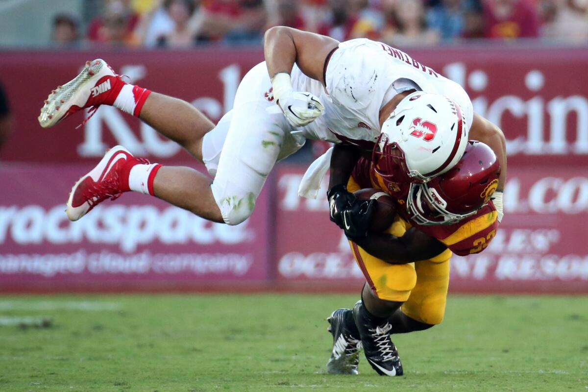 Stanford linebacker Blake Martinez brings down USC running back Tre Madden during the second half.