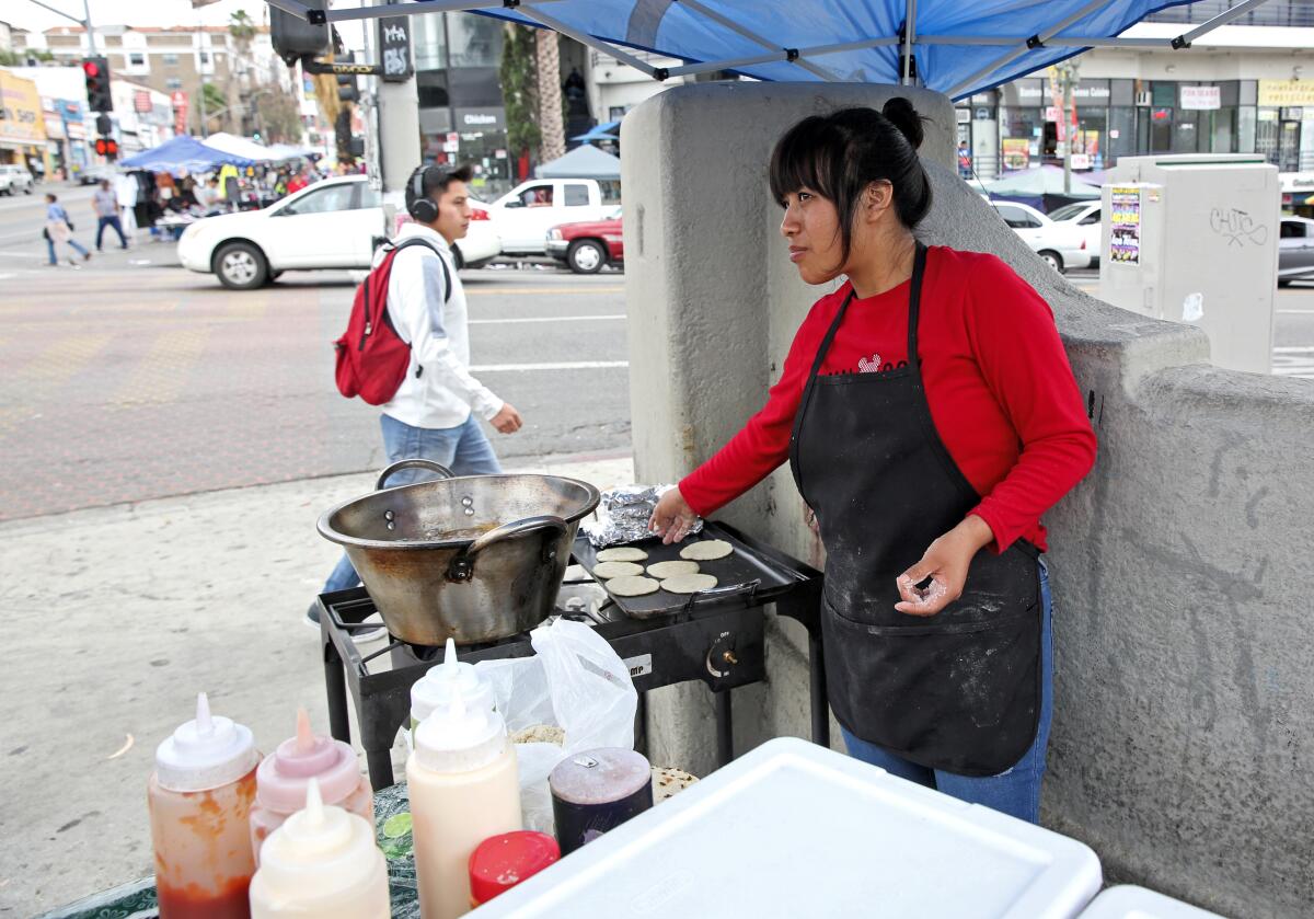 A woman makes tortillas