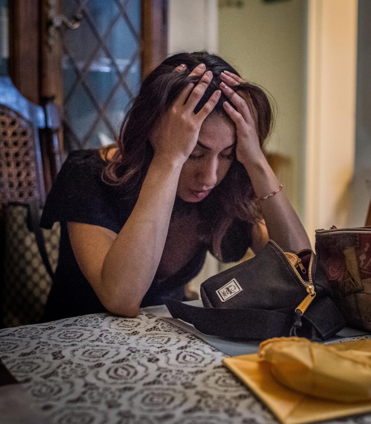 After her daughter's kindergarten graduation, Natalie Garcia sits in exhaustion at her home in Arleta.
