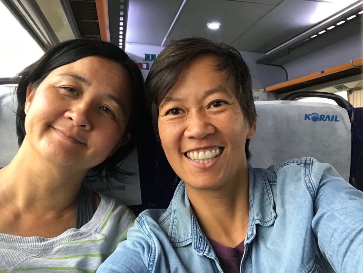 Amber Field, right, with her wife, Monique Miyake, on a train in Korea.