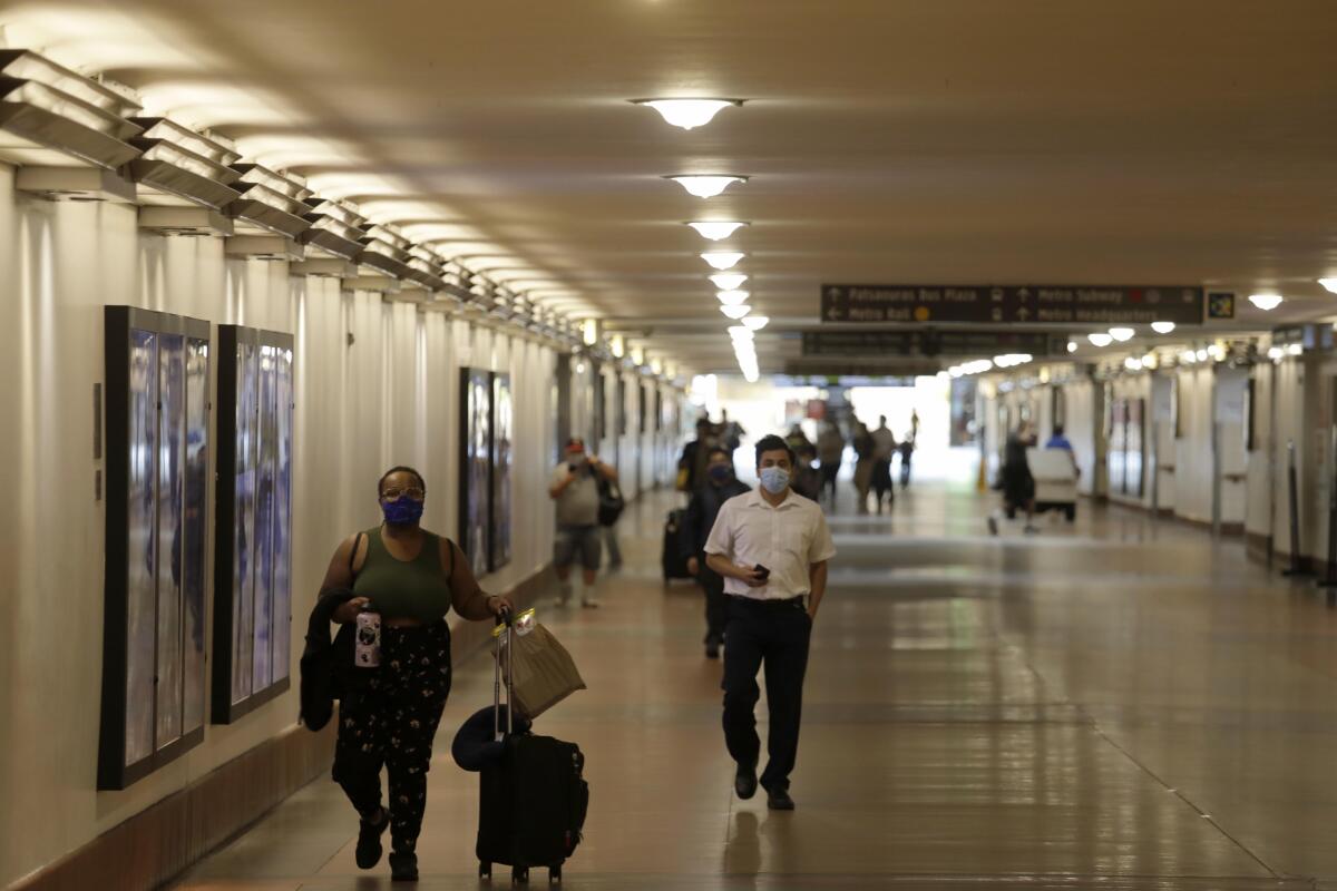 Travelers wear masks at Union Station on June 15.