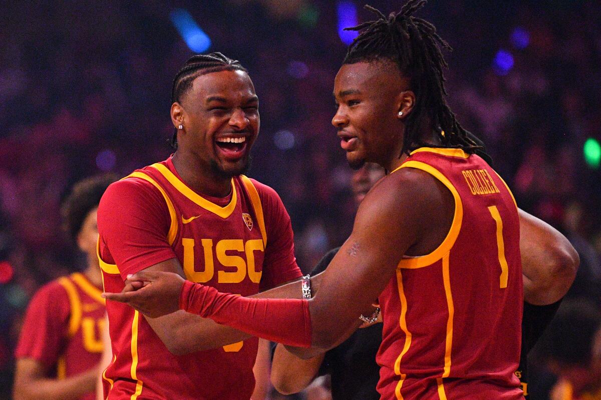 USC guard Bronny James jokes with guard Isaiah Collier.