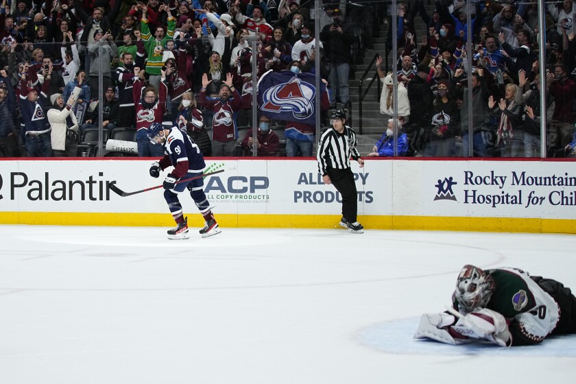 Arizona Coyotes goaltender Ivan Prosvetov lays on the ice as Colorado Avalanche center Nazem Kadri (91) celebrates a game winning shoot out goal during an NHL hockey game Friday, Jan. 14, 2022, in Denver. (AP Photo/Jack Dempsey)