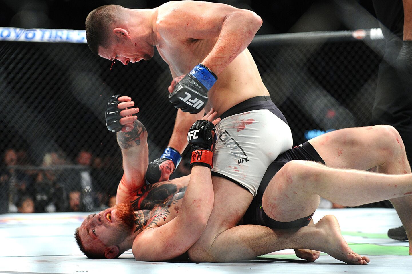 Nate Diaz takes down Conor McGregor during their non-title welterweight bout at UFC 196 in Las Vegas on March 5.