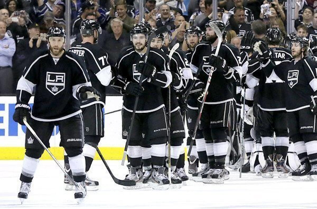 Kings players congratulate each other after beating the San Jose Sharks in Game 7 of their playoff series.