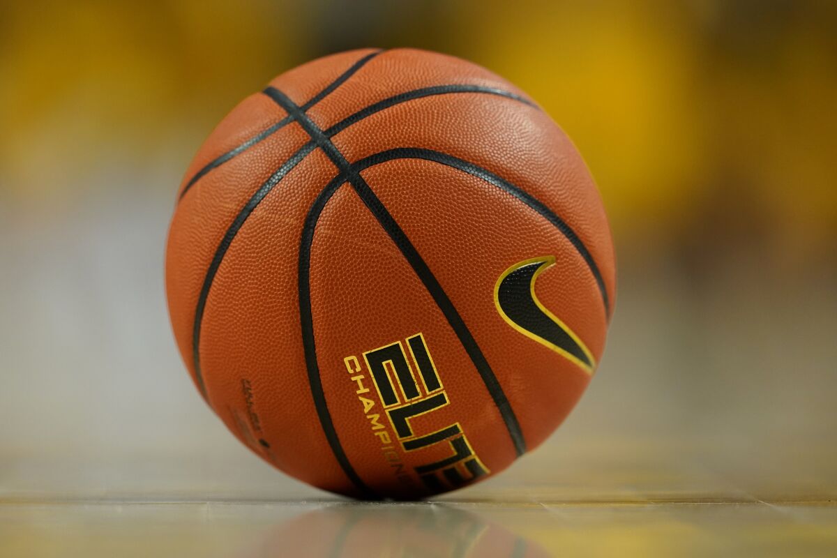 A basketball sits on the court.