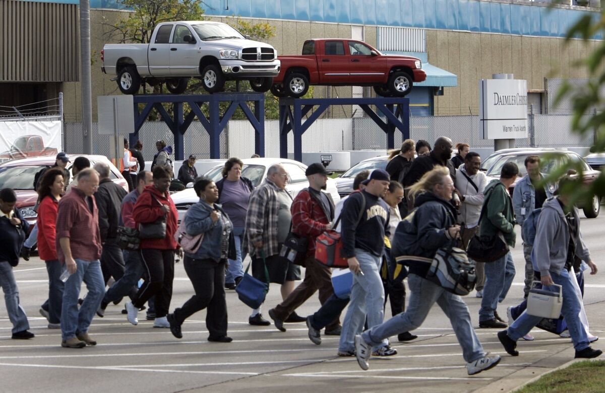 Workers leave a Chrysler factory in Warren, Mich., in 2007.