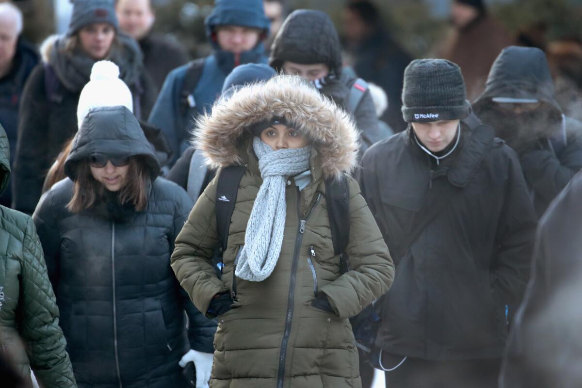 Commuters brave sub-zero temperatures as they make their way to work in Chicago on Tuesday. Record cold temperatures are gripping much of the U.S.