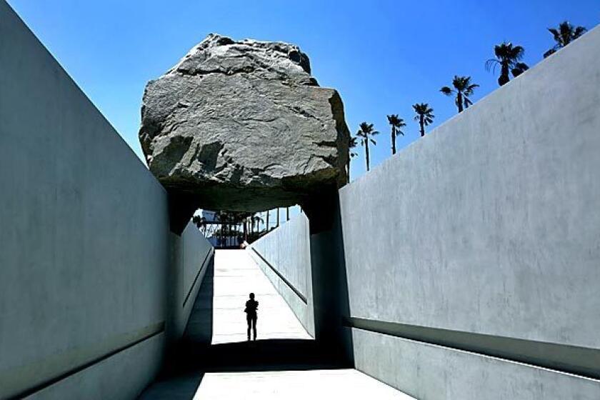 Michael Heizer's "Levitated Mass," the commissioned sculpture at the Los Angeles County Museum of Art, gives visitors the chance to walk underneath a 340-ton granite boulder. The sculpture opens to the public on June 24.