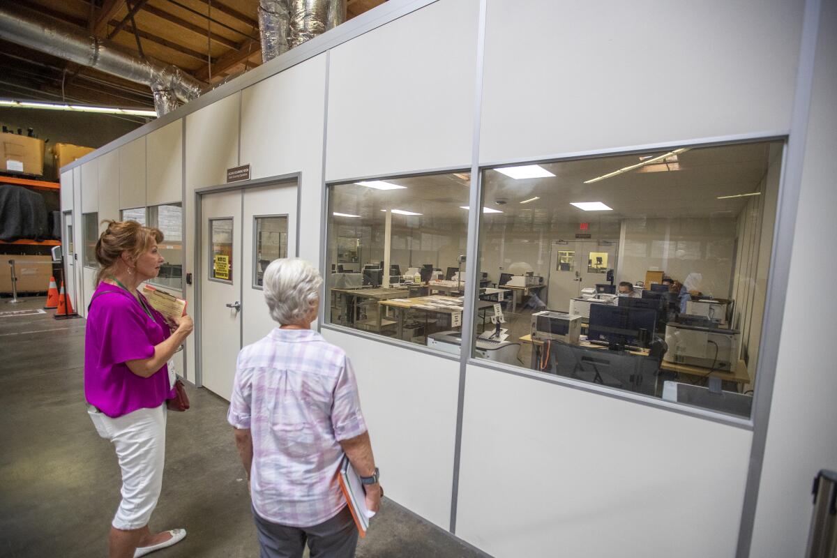 People watch a ballot count