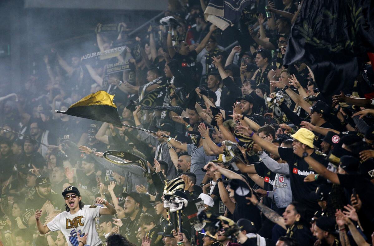 Fans of Los Angeles FC waving flags and setting off colors smoke bombs to celebrate their extra time win against Seattle Sounders in the second half of an MLS soccer game at Banc of California Stadium in Los Angeles, Sunday, April 29, 2018. The Los Angeles FC won 1-0.