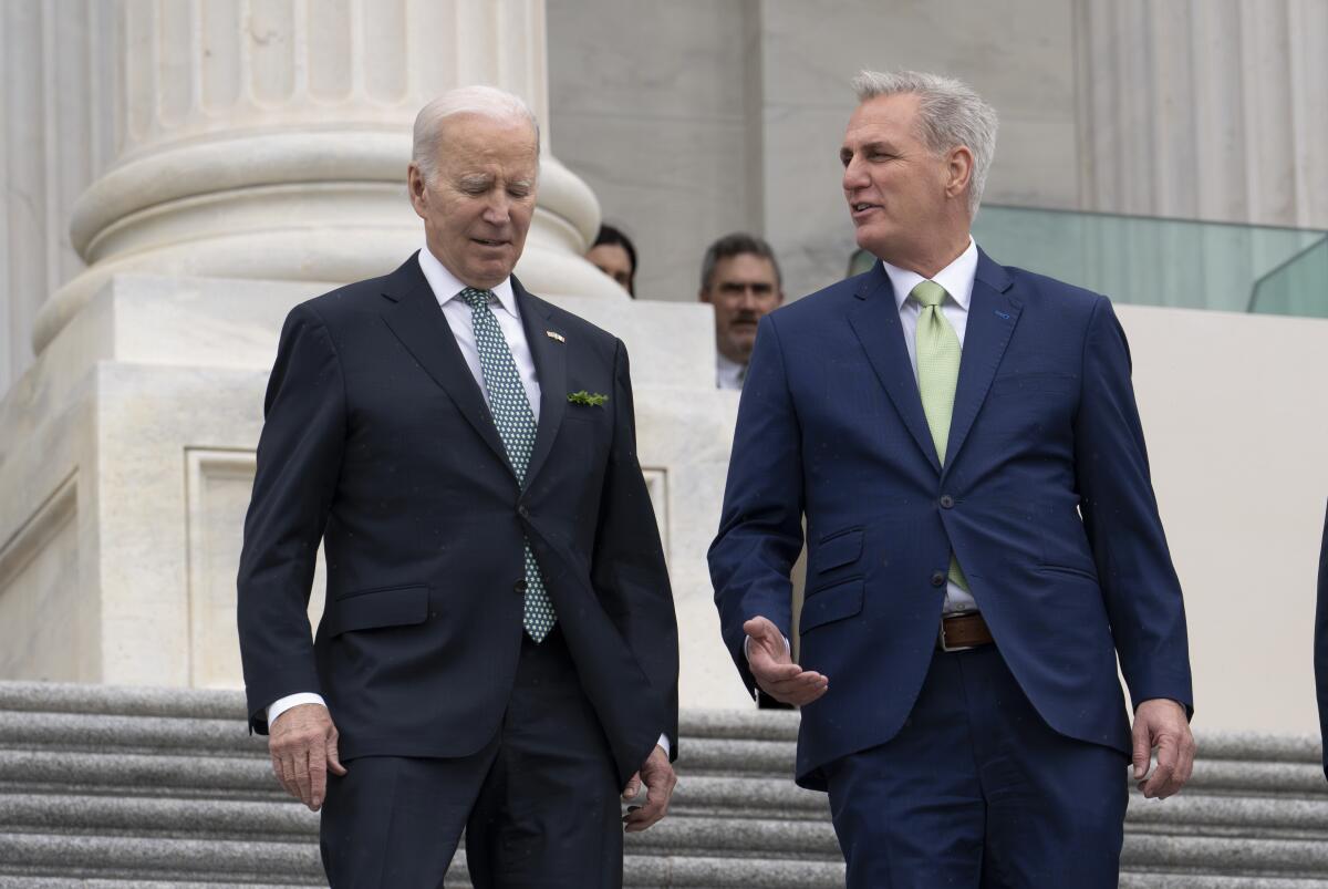 President Biden and House Speaker Kevin McCarthy talking as they walk down the front steps of the U.S. Capitol