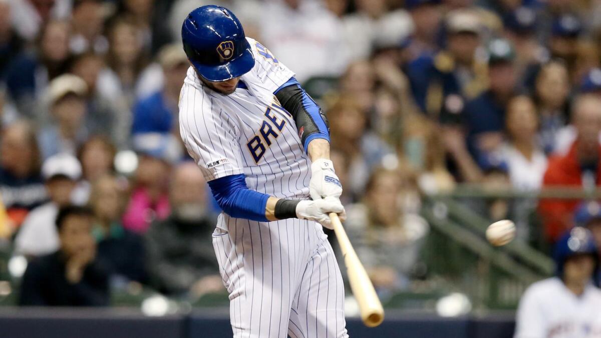 Milwaukee's Ryan Braun connects for a three-run home run against the Dodgers during the seventh inning Saturday.