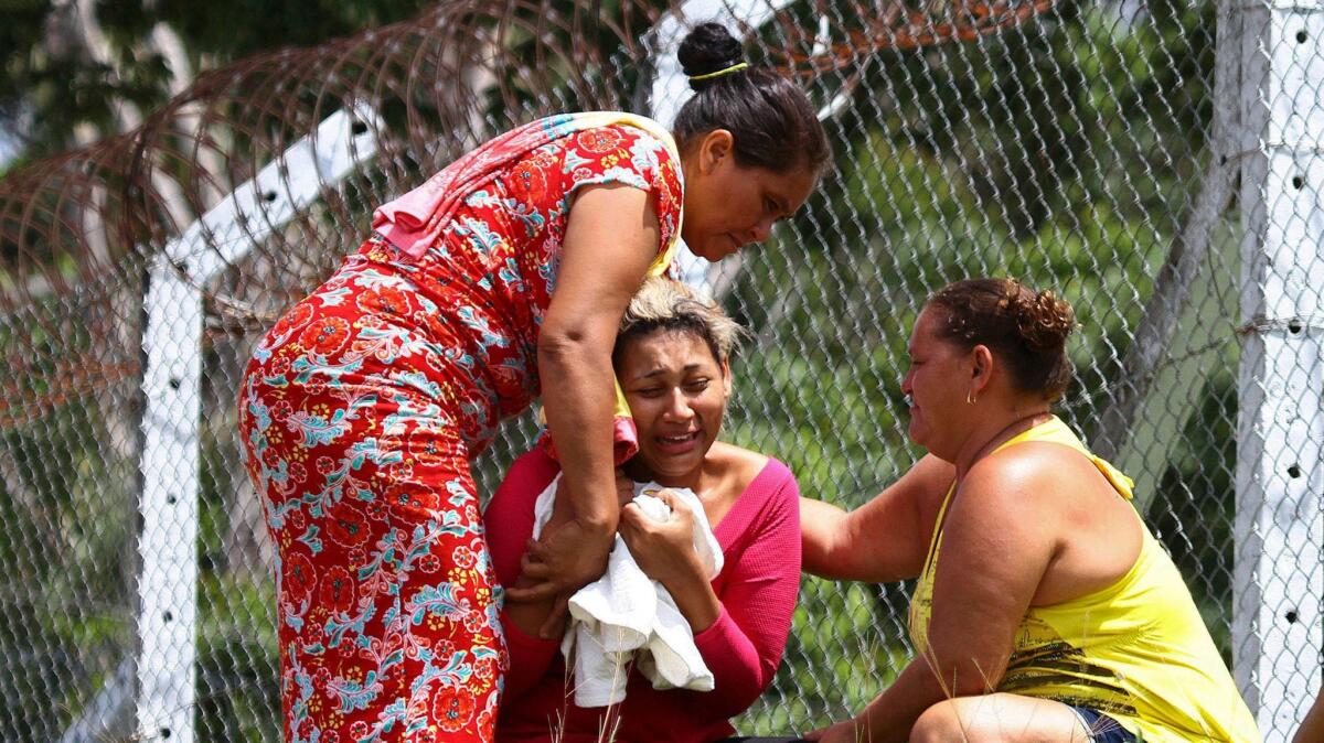 The wife of a prisoner who was killed in the riot cries outside Anisio Jobim Penitentiary Complex in Manaus, Brazil, on Monday.