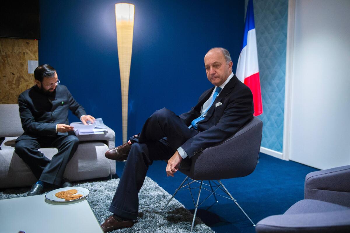 French Foreign Affairs Minister Laurent Fabius, right, meets with Indian Environment Minister Prakash Javadekar at the COP 21 U.N. Conference on climate change.