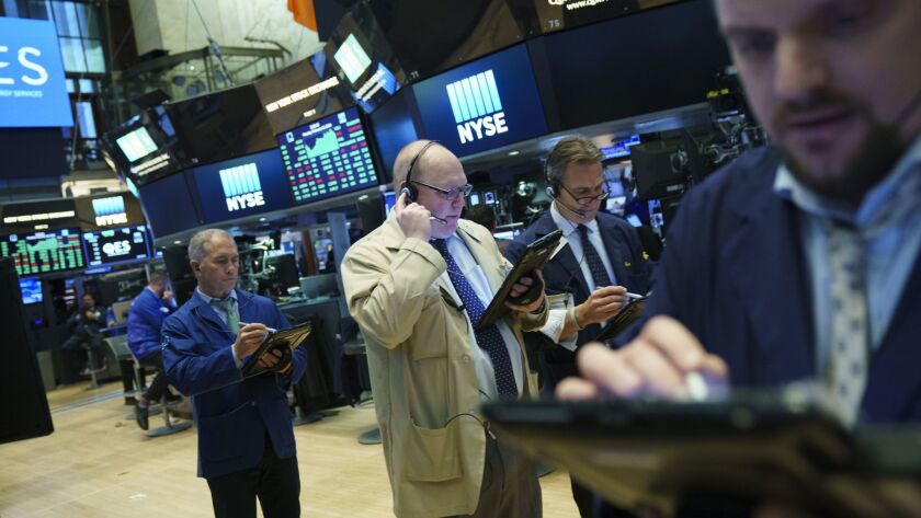 Traders and financial professionals work on the floor of the New York Stock Exchange.
