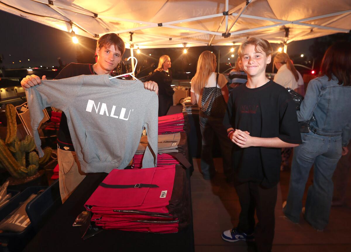 Nalu founder Finn Schonfelder, left, and Hero Glowaki, hold a pop-up event of Nalu clothing and accessories.