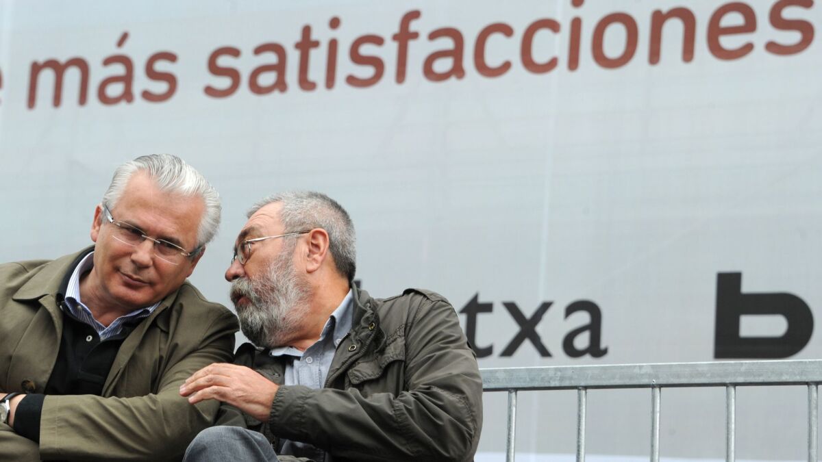 Former Judge Baltasar Garzon, left, listens to union leader Candido Mendez during a 2012 demonstration in Madrid to demand justice for the Spanish victims of Francisco Franco's dictatorship.