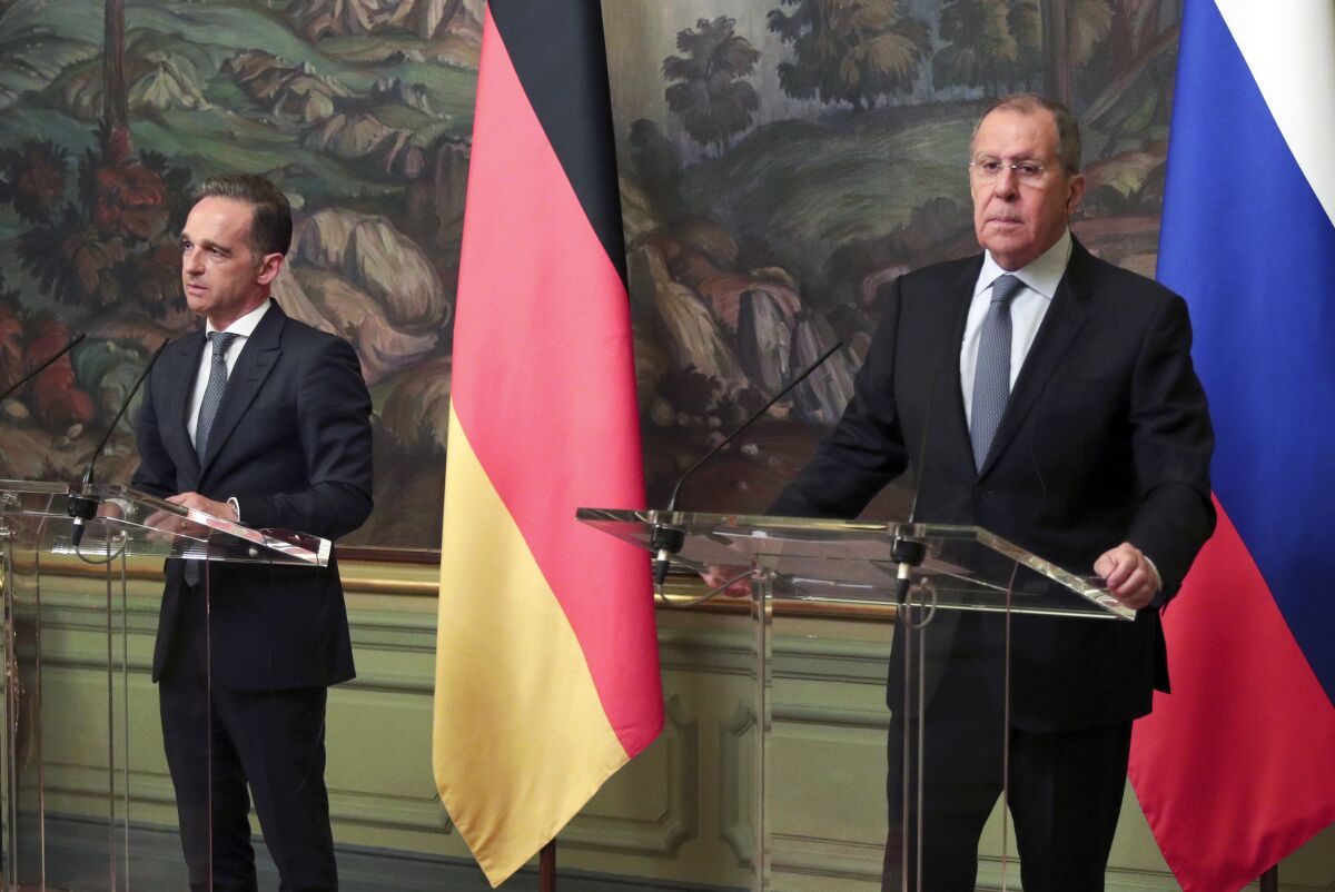 Russian Foreign Minister Sergey Lavrov, right, and German Foreign Minister Heiko Maas, attend a joint news conference following their talks in Moscow, Russia, Tuesday, Aug. 11, 2020. (Russian Foreign Ministry Press Service via AP)
