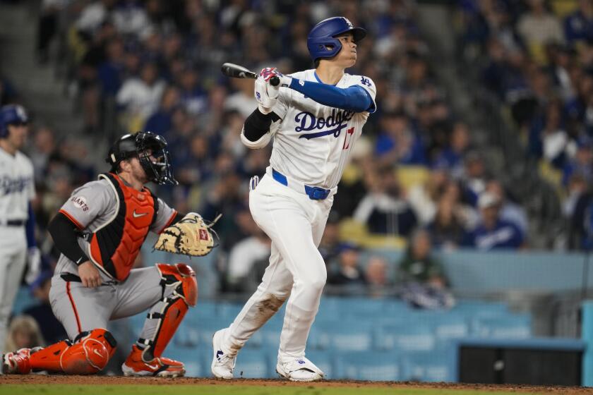 Los Angeles Dodgers designated hitter Shohei Ohtani hits a home run during the seventh inning of a baseball game against the San Francisco Giants in Los Angeles, Wednesday, April 3, 2024. (AP Photo/Ashley Landis)