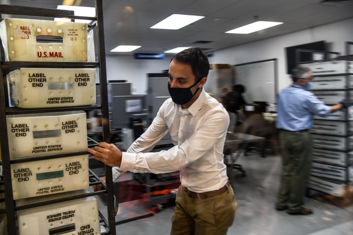 Electoral workers process ballots at the Miami-Dade County Election Department in Florida on Tuesday