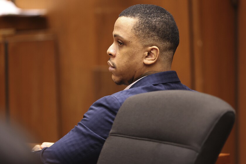 Defendant Eric Holder listens during opening statements in his murder trial, Wednesday, June 15, 2022, at Los Angeles Superior Court in Los Angeles. Holder, 32, faces one count of first degree-murder and two counts of attempted first-degree murder for the killing the Grammy Award-winning rapper Nipsey Hussle outside his clothing store three years ago. (Frederick M. Brown/Daily Mail.com via AP, Pool)
