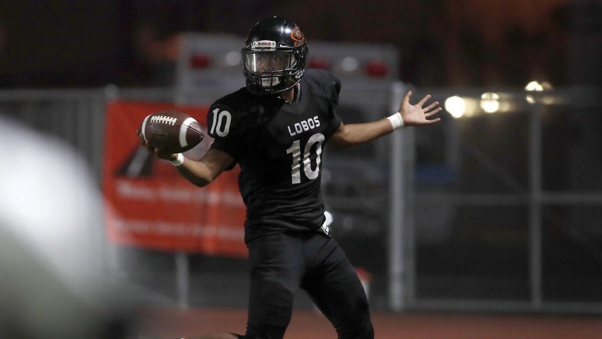 Los Amigos High's Brian Pacheco, shown scoring a touchdown against Saddleback on Sept. 6, finished with 167 rushing yards and 132 receiving yards in the Lobos' 45-0 win at Costa Mesa on Friday,