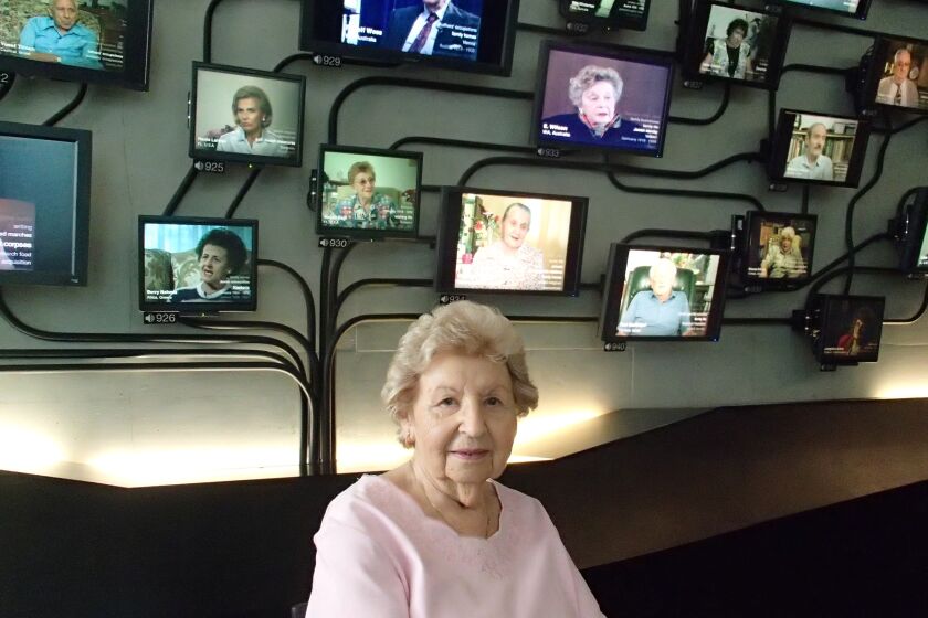 Undated handout photo of Edith Frankie in front of the Tree of Testimony at Los Angeles Museum of the Holocaust.The Tree of Testimony is a 70-screen video sculpture comprised of nearly 51,000 video testimonies of Holocaust survivors over the course of a single year. (John Pregulman / Museum of the Holocaust)